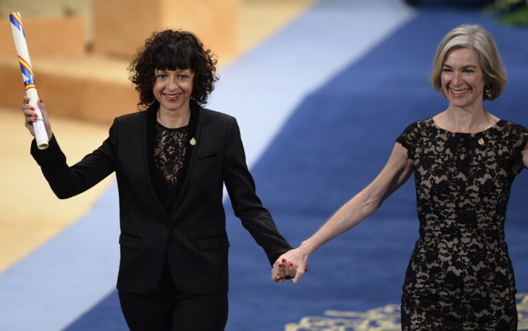 French researcher in Microbiology, Genetics and Biochemistry Emmanuelle Charpentier (L) and US professor of Chemistry and of Molecular and Cell Biology, Jennifer Doudna celebrate on the stage after receiving the 2015 Princess of Asturias Award for Technical and Scientific Reseach from Spain's King Felipe during the Princess of Asturias awards ceremony at the Campoamor Theatre in Oviedo, on October 23, 2015.